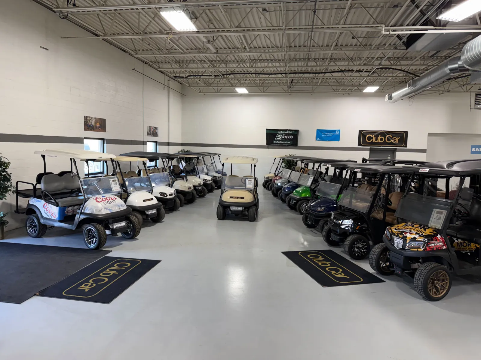 MOR Golf and Utility showroom floor lined with used Club Car golf carts